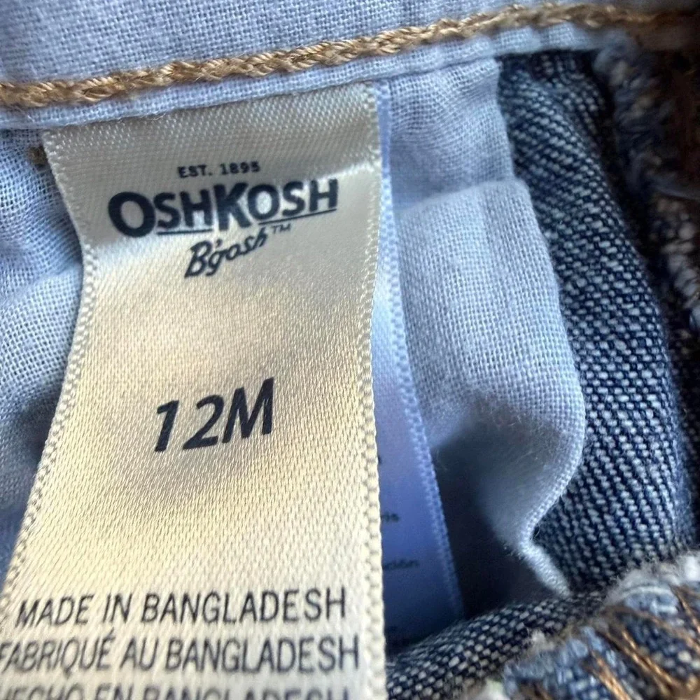 OshKosh B'gosh blue denim overalls with pink heart embroidery